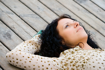 Image showing woman lying on wooden floor