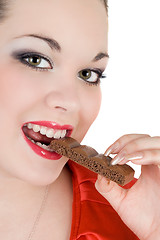 Image showing Portrait of the young woman eating chocolate