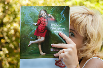 Image showing girl reading magazine