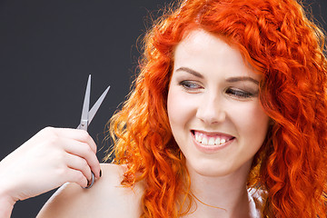 Image showing redhead with scissors