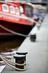 Image showing boats docked in harbor bollards