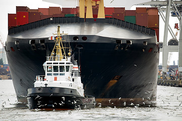 Image showing tugboat towing freighter in harbor