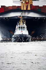 Image showing tugboat pulling freighter