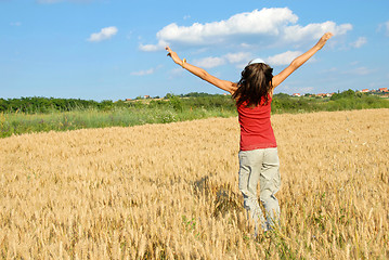 Image showing Happy girl jumping in wheat field