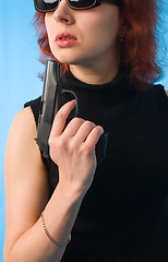 Image showing redhaired woman with pistol