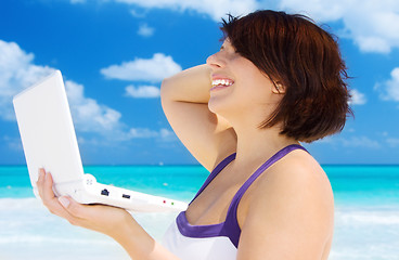 Image showing woman with laptop computer on the beach