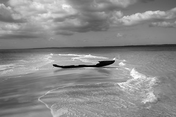 Image showing ruined fisherman boat on sandy shielf - monochrome