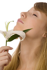 Image showing young girl smelling lily
