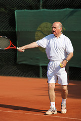 Image showing a aktive senior is playing tennis