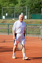 Image showing a aktive senior is playing tennis