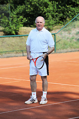 Image showing a aktive senior is playing tennis