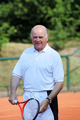 Image showing a aktive senior is playing tennis