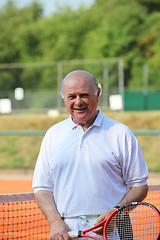 Image showing a aktive senior is playing tennis