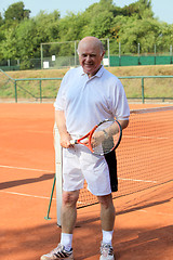 Image showing a aktive senior is playing tennis