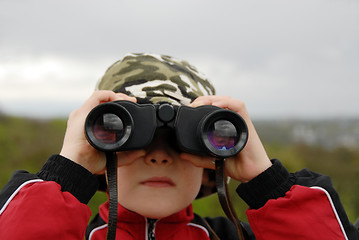 Image showing boy observing nature through binoculars