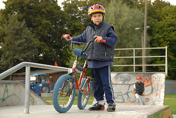 Image showing Young boy rides bicycle