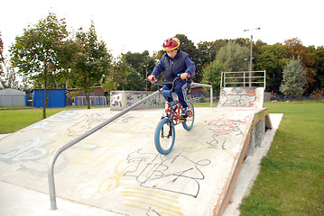 Image showing Young boy rides bicycle