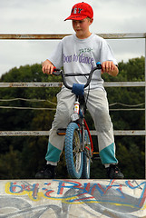 Image showing Young boy rides bicycle