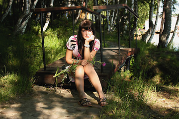 Image showing The thoughtful girl with a thistle in hands