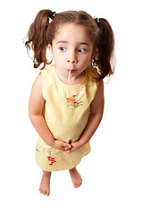 Image showing Cute girl sucking on a lollipop candy