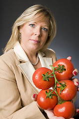 Image showing woman with bunch of fresh ripe tomatoes