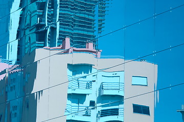 Image showing Reflection of a building in glass wall of an office building