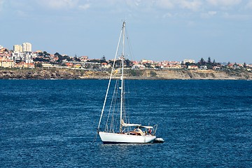 Image showing The large, beautiful yacht in the light-blue sea.