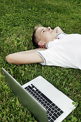 Image showing Boy lying on grass 