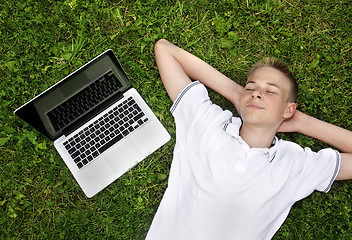 Image showing Boy lying on grass