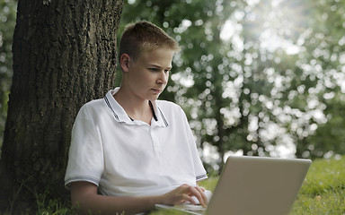 Image showing Young man using laptop i