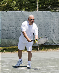 Image showing middle age tennis player forehand on court