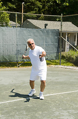 Image showing middle age tennis player forehand on court