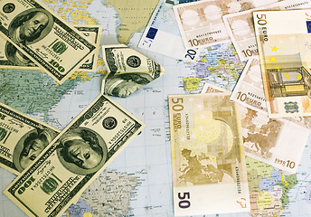 Image showing Dollars and Euro on a world card