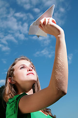 Image showing paper plane in hand of the young girl