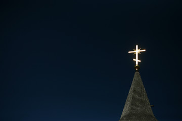 Image showing Lighting orthodox cross on a blue sky 