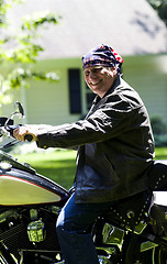 Image showing middle age man on motorcycle with american flag bandana