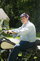 Image showing middle age man on motorcycle with american flag bandana