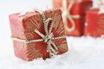 Image showing Christmas gifts with red wrapping and decorative bows.