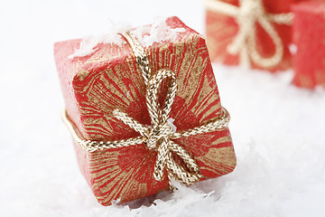 Image showing Christmas gifts with red wrapping and decorative bows.