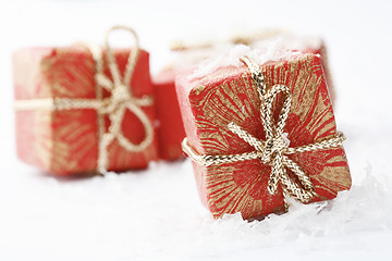 Image showing Christmas gifts with red wrapping and decorative bows.