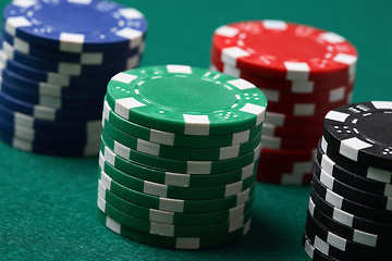 Image showing Stacks of poker chips on a green surface.