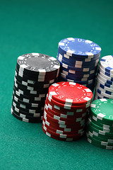 Image showing Stacks of poker chips on a green surface.