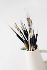 Image showing Set of paintbrushes in jug.