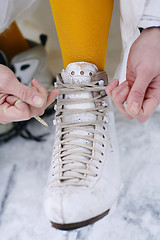 Image showing Putting on ice skates.