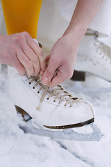 Image showing Putting on ice skates.