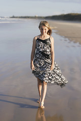 Image showing Pretty teenager walking on the beach.