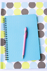 Image showing Brightly colored notebook, folder and pen.