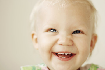 Image showing Portrait of a smiling and laughing toddler.