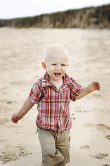 Image showing A happy little boy at the beach. 