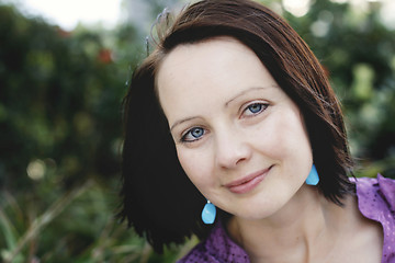 Image showing Close-up portrait of a smiling beautiful woman outdoors.